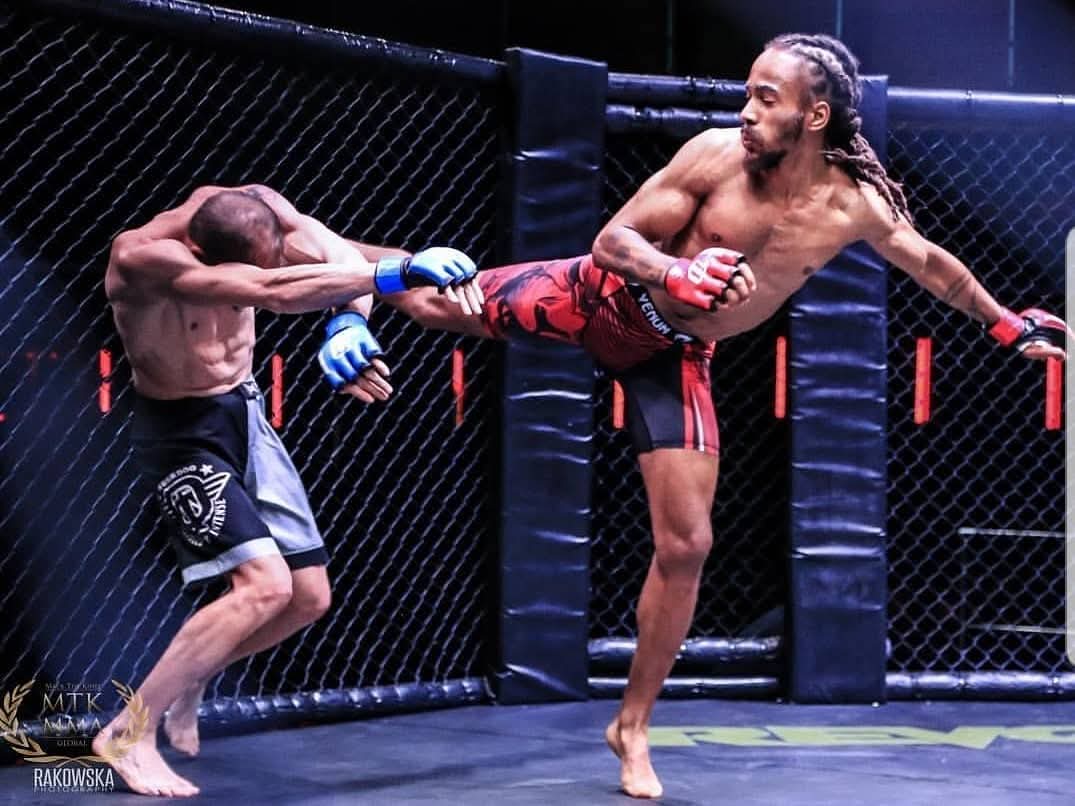 Rico Biggs landing a head kick in an MMA bout at MTK MMA